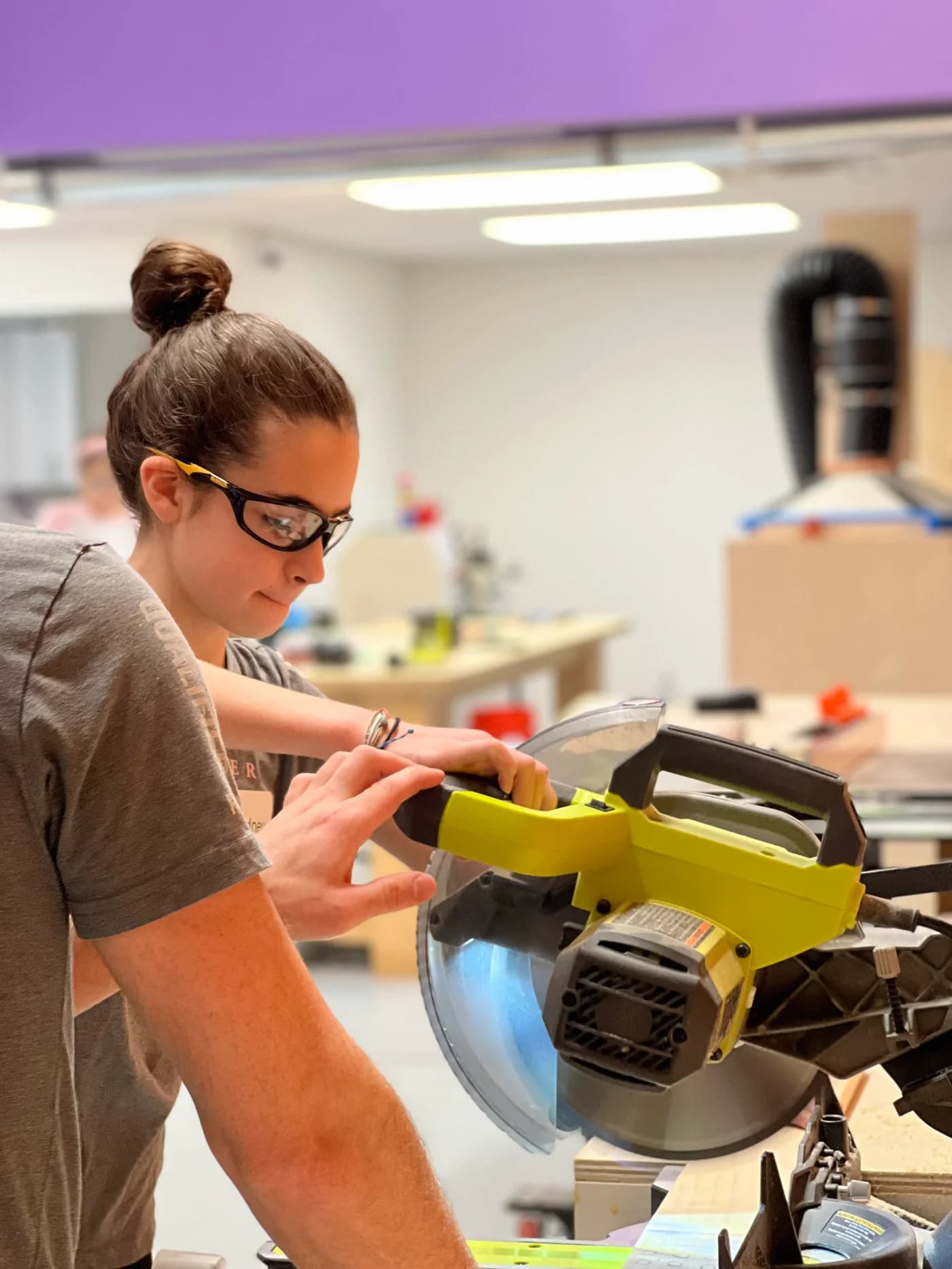 Guild Hall maker wearing safety glasses while working on a wood project