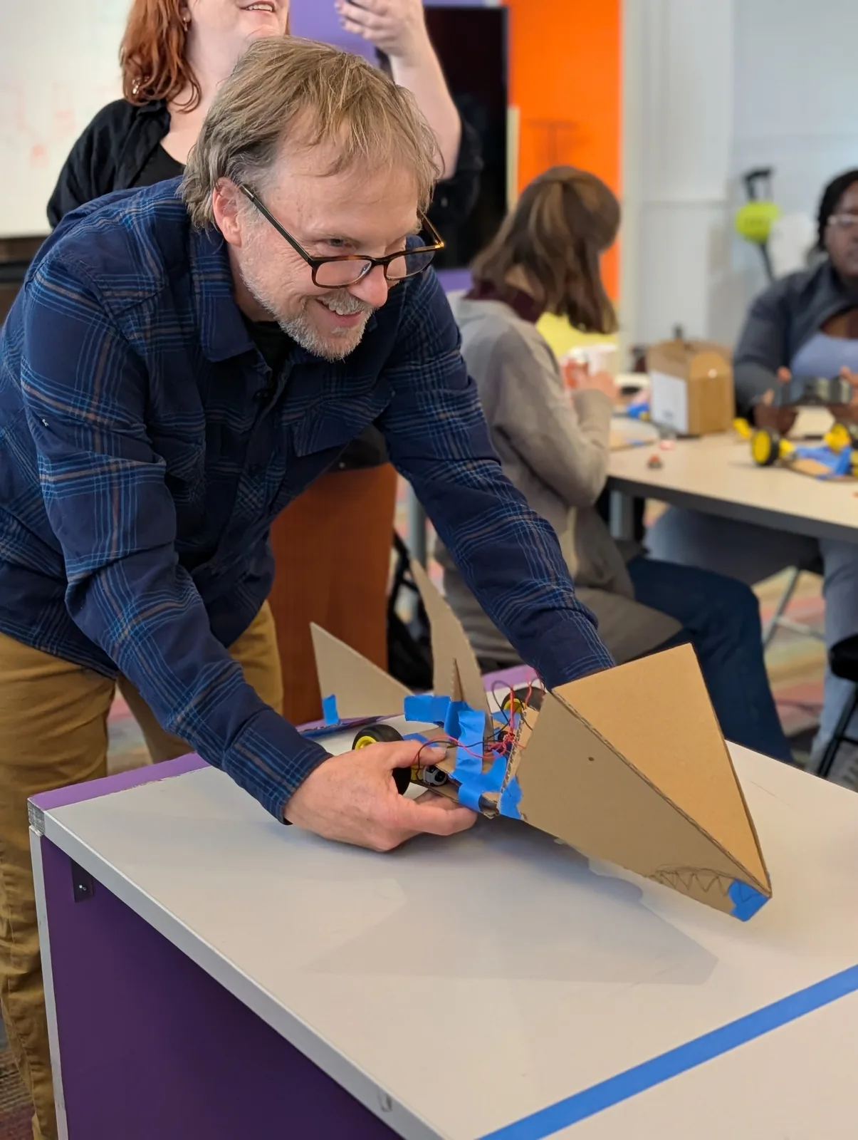 An adult participant testing a cardboard robot