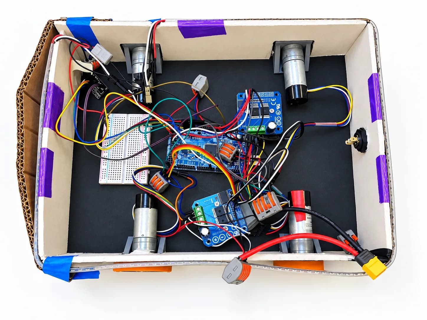 An open robot chassis containing motors, circuit boards and connected wiring